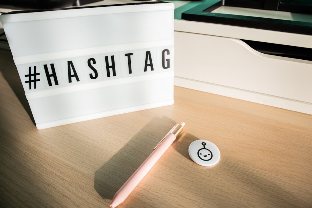 a pink pen sitting on top of a wooden table