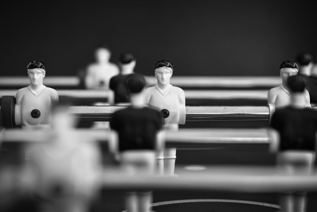 Foosball players lined up on a table