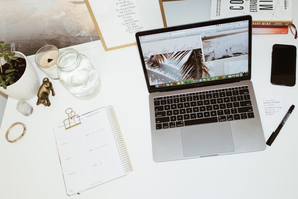 a laptop computer sitting on top of a white desk